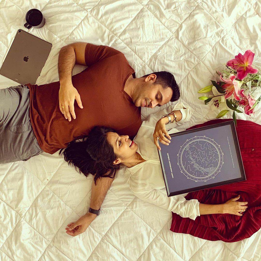 Couple Lay down while holding a star map on top